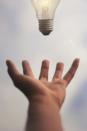 person catching light bulb